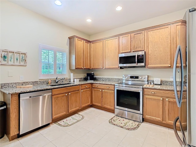 501 Heartwell Dr, Poinciana, FL 34759 - kitchen featuring a sink, stainless steel appliances, recessed lighting, and light stone counters