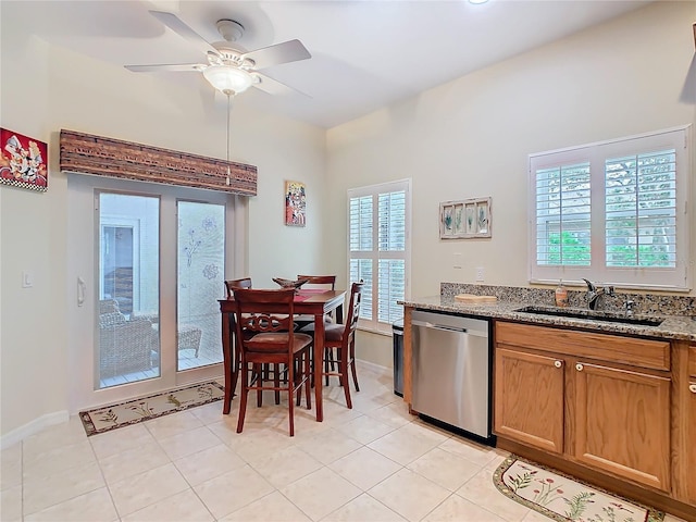 501 Heartwell Dr, Poinciana, FL 34759 - kitchen featuring light stone countertops, plenty of natural light, ceiling fan, and dishwasher