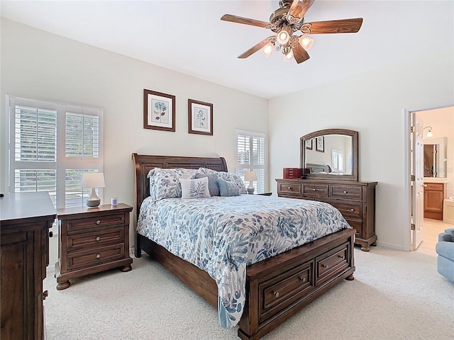 501 Heartwell Dr, Poinciana, FL 34759 - bedroom featuring light carpet, baseboards, ceiling fan, and ensuite bath