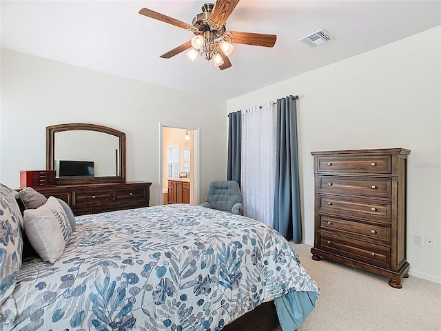 501 Heartwell Dr, Poinciana, FL 34759 - bedroom featuring visible vents, baseboards, ceiling fan, connected bathroom, and light colored carpet