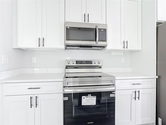 kitchen featuring white cabinetry, light countertops, and stainless steel appliances