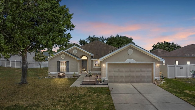 323 Azincourt Ln, Kissimmee, FL 34759 - ranch-style home with a front lawn, driveway, an attached garage, and fence