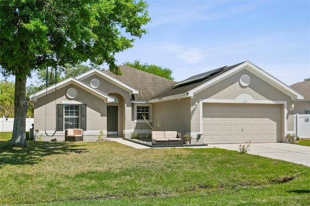 323 Azincourt Ln, Kissimmee, FL 34759 - single story home with an attached garage, concrete driveway, a front yard, solar panels, and stucco siding