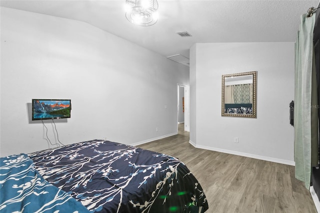 323 Azincourt Ln, Kissimmee, FL 34759 - unfurnished bedroom with visible vents, baseboards, vaulted ceiling, and wood finished floors