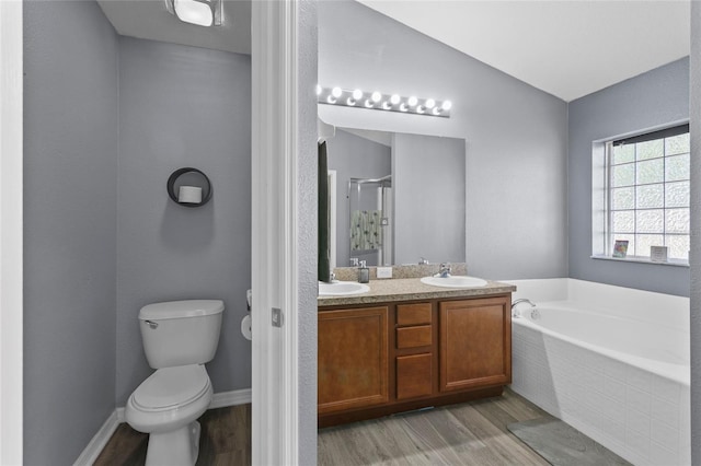 323 Azincourt Ln, Kissimmee, FL 34759 - bathroom with a stall shower, a sink, wood finished floors, a bath, and double vanity