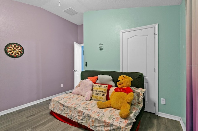 323 Azincourt Ln, Kissimmee, FL 34759 - bedroom with baseboards, visible vents, vaulted ceiling, and wood finished floors