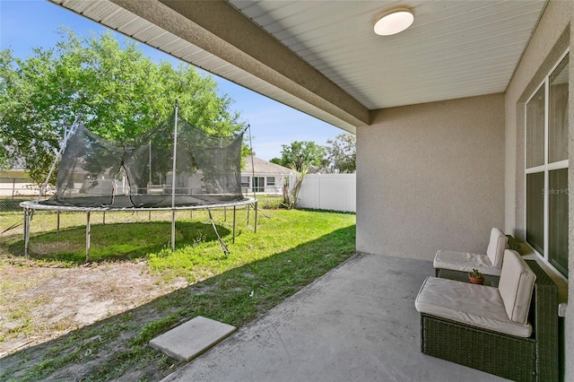 323 Azincourt Ln, Kissimmee, FL 34759 - view of patio / terrace featuring fence and a trampoline