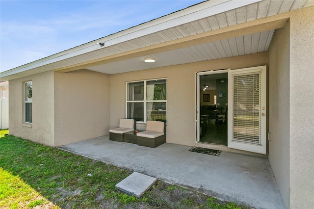 323 Azincourt Ln, Kissimmee, FL 34759 - doorway to property featuring stucco siding and a patio