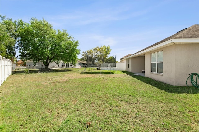 323 Azincourt Ln, Kissimmee, FL 34759 - view of yard with a fenced backyard and a trampoline