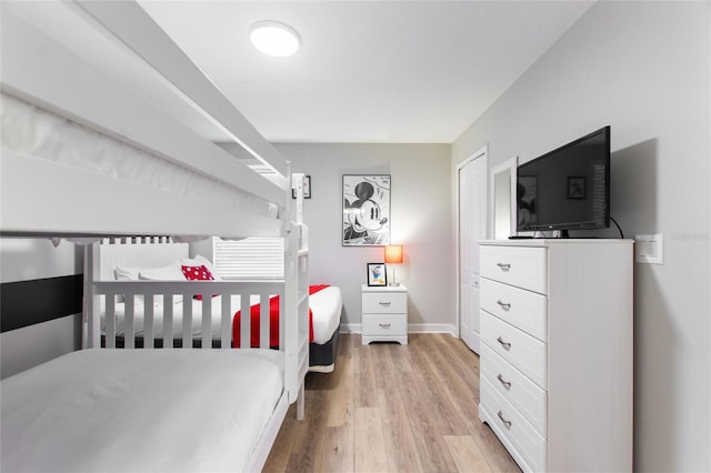 bedroom with baseboards and light wood-type flooring