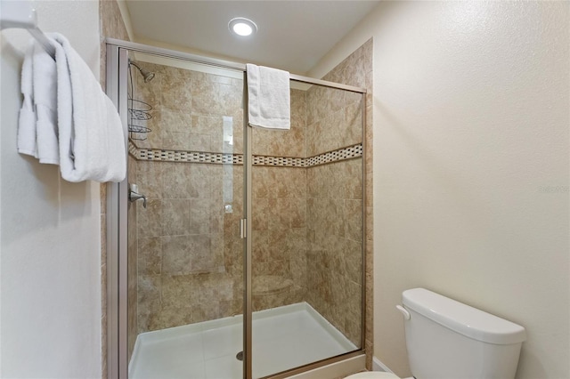 full bath featuring toilet and a stall shower