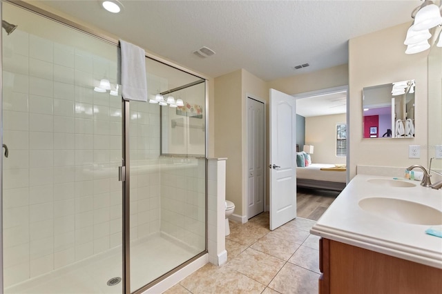 full bathroom with visible vents, connected bathroom, a sink, and a stall shower