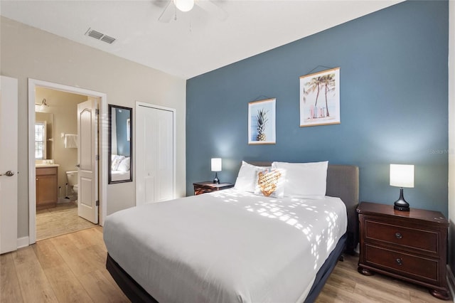 bedroom with a ceiling fan, light wood-style flooring, a closet, and visible vents
