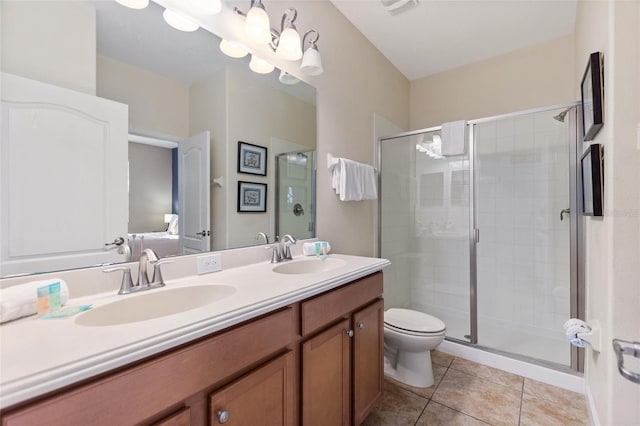 bathroom with a stall shower, tile patterned floors, double vanity, and a sink