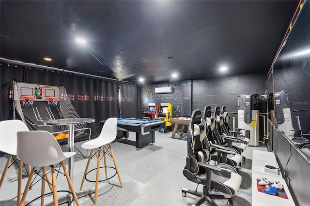 rec room featuring concrete block wall, a wall unit AC, speckled floor, and billiards