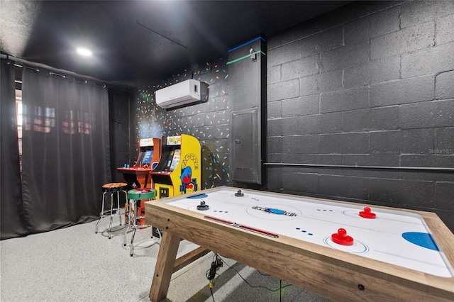 playroom featuring a wall mounted air conditioner, concrete block wall, and electric panel