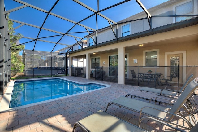 pool featuring a lanai and a patio area