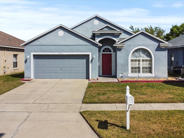 7733 Beridale Ct, Orlando, FL 32818 - ranch-style home with stucco siding, an attached garage, concrete driveway, and a front yard