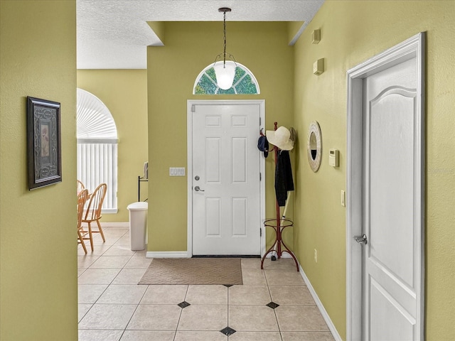 7733 Beridale Ct, Orlando, FL 32818 - foyer with baseboards, a textured ceiling, and light tile patterned floors