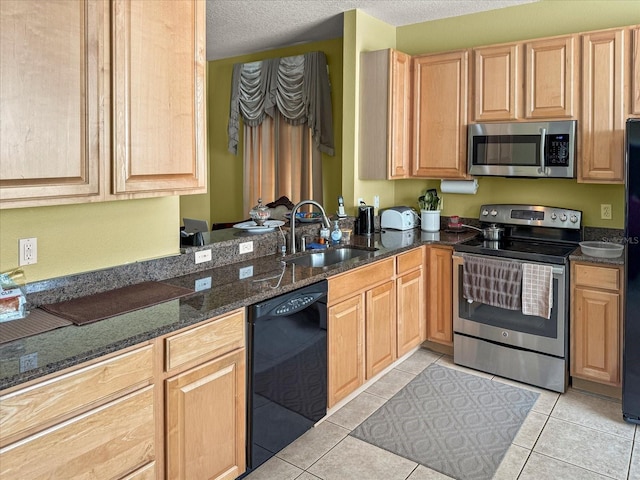 7733 Beridale Ct, Orlando, FL 32818 - kitchen with a sink, light brown cabinets, black appliances, and a textured ceiling