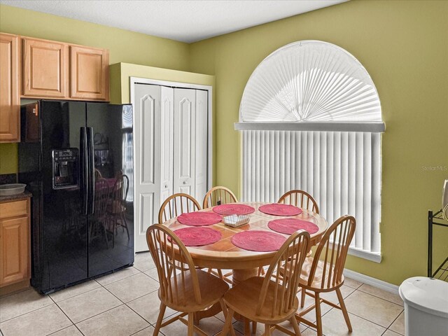 7733 Beridale Ct, Orlando, FL 32818 - dining room featuring baseboards and light tile patterned floors
