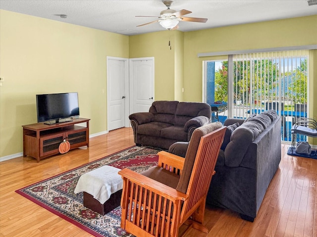 7733 Beridale Ct, Orlando, FL 32818 - living room with baseboards, wood finished floors, and a ceiling fan