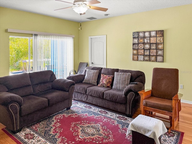 7733 Beridale Ct, Orlando, FL 32818 - living area featuring baseboards, visible vents, wood finished floors, and ceiling fan