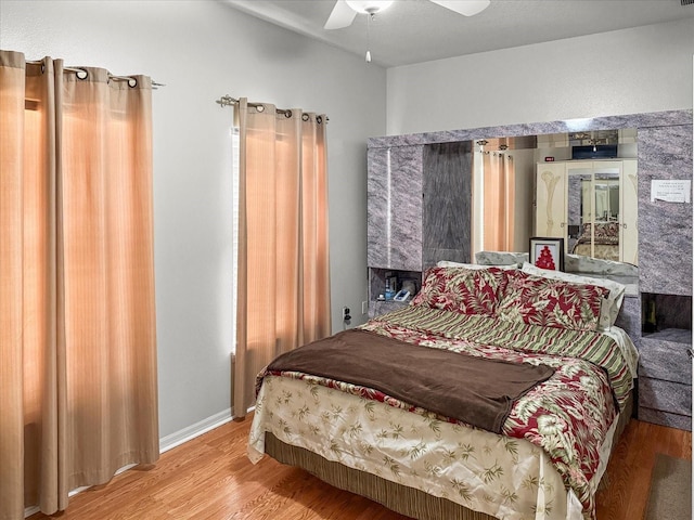 7733 Beridale Ct, Orlando, FL 32818 - bedroom featuring a fireplace, ceiling fan, and wood finished floors