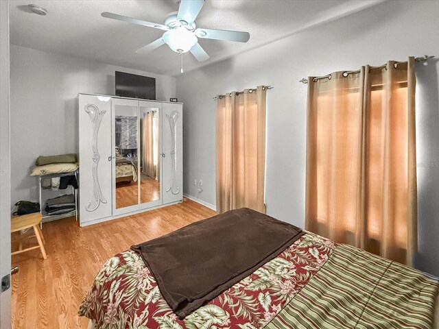 7733 Beridale Ct, Orlando, FL 32818 - bedroom featuring light wood-type flooring and a ceiling fan