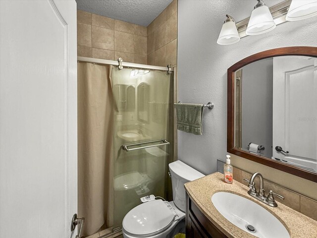 7733 Beridale Ct, Orlando, FL 32818 - bathroom with a textured ceiling, a shower stall, toilet, vanity, and a textured wall