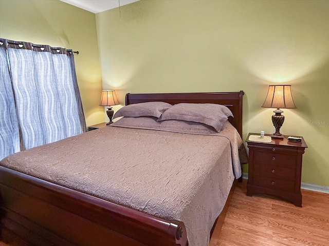 7733 Beridale Ct, Orlando, FL 32818 - bedroom featuring baseboards and wood finished floors