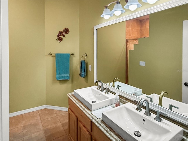 7733 Beridale Ct, Orlando, FL 32818 - bathroom with baseboards, double vanity, a sink, and tile patterned flooring