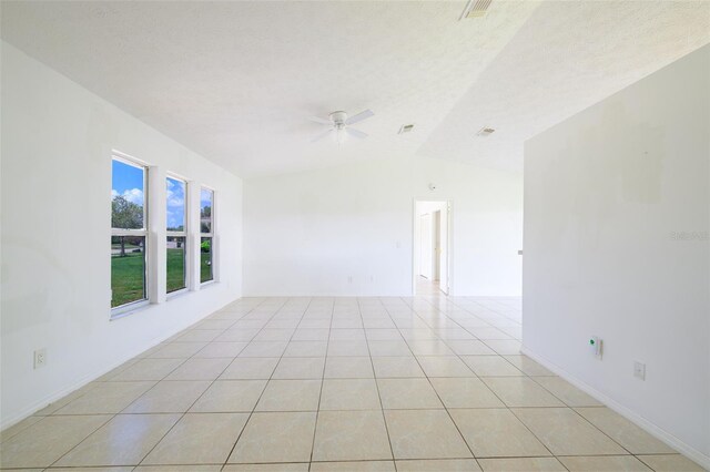 554 NW Twylite Ter, Port St Lucie, FL 34983 - spare room featuring ceiling fan, lofted ceiling, and light tile patterned floors