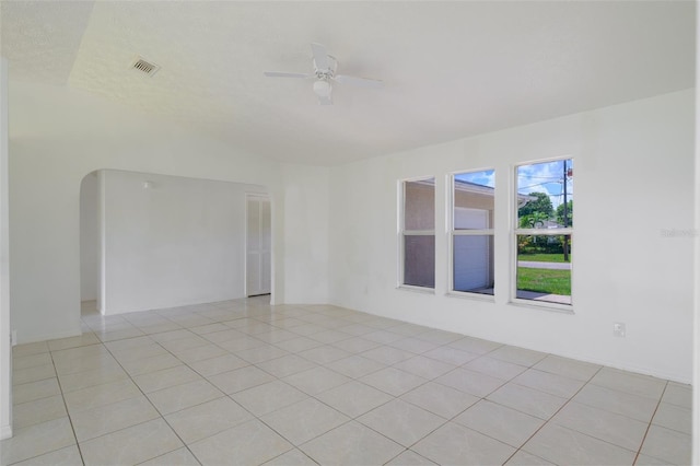 554 NW Twylite Ter, Port St Lucie, FL 34983 - spare room featuring vaulted ceiling, ceiling fan, light tile patterned flooring, and arched walkways