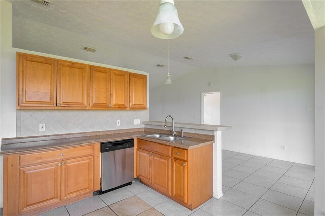 554 NW Twylite Ter, Port St Lucie, FL 34983 - kitchen featuring dishwasher, a sink, vaulted ceiling, decorative backsplash, and a peninsula