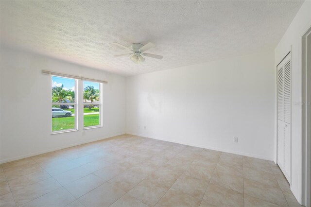 554 NW Twylite Ter, Port St Lucie, FL 34983 - spare room with ceiling fan, a textured ceiling, and baseboards