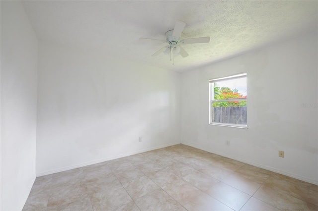 554 NW Twylite Ter, Port St Lucie, FL 34983 - tiled empty room featuring ceiling fan, baseboards, and a textured ceiling