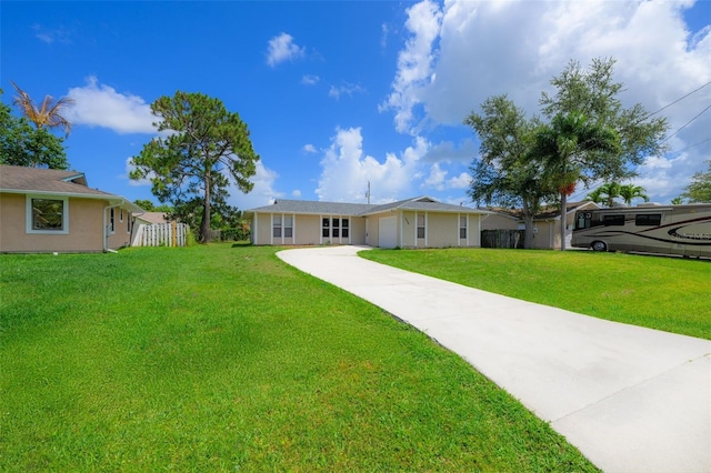 554 NW Twylite Ter, Port St Lucie, FL 34983 - view of front facade with concrete driveway, a front yard, a garage, and stucco siding