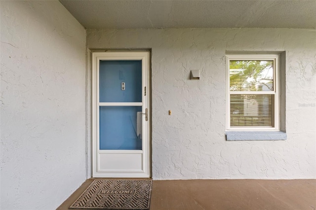entrance to property with stucco siding