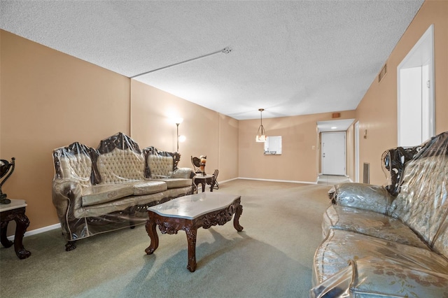 living room with baseboards, visible vents, carpet, and a textured ceiling