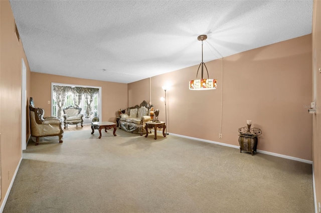 living area with baseboards, carpet floors, and a textured ceiling
