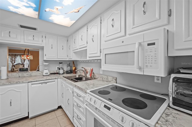 kitchen featuring light countertops, a sink, white cabinetry, white appliances, and visible vents