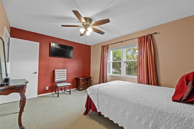 bedroom featuring carpet flooring, a ceiling fan, baseboards, and a textured ceiling