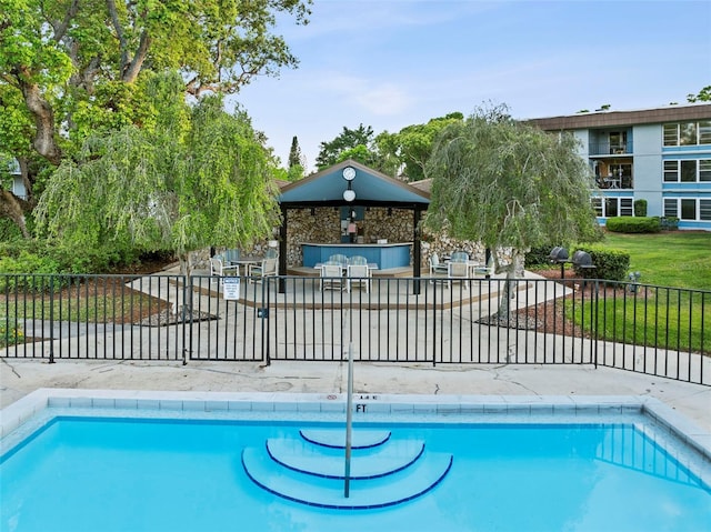 pool featuring a gazebo and fence
