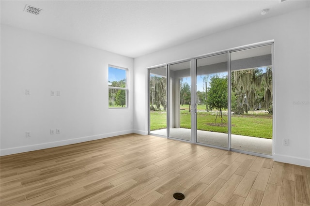 4083 Bannock Ave, Tavares, FL 32778 - empty room with light wood finished floors and a smoke detector