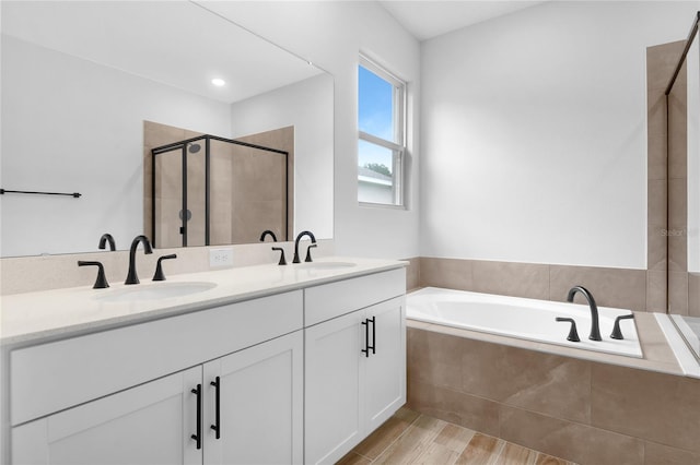 4083 Bannock Ave, Tavares, FL 32778 - bathroom with a garden tub, a stall shower, double vanity, and wood finished floors