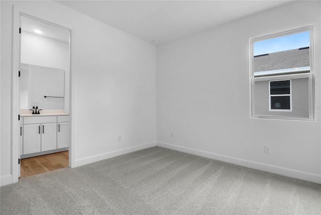 4083 Bannock Ave, Tavares, FL 32778 - unfurnished bedroom with light colored carpet, ensuite bath, and recessed lighting
