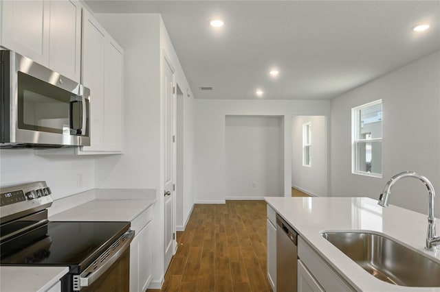 4079 Bannock Ave, Tavares, FL 32778 - kitchen with appliances with stainless steel finishes, recessed lighting, dark wood finished floors, white cabinets, and light stone countertops