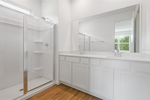 4079 Bannock Ave, Tavares, FL 32778 - bathroom featuring a stall shower, double vanity, and wood finished floors