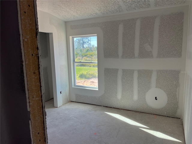 spare room with a textured ceiling